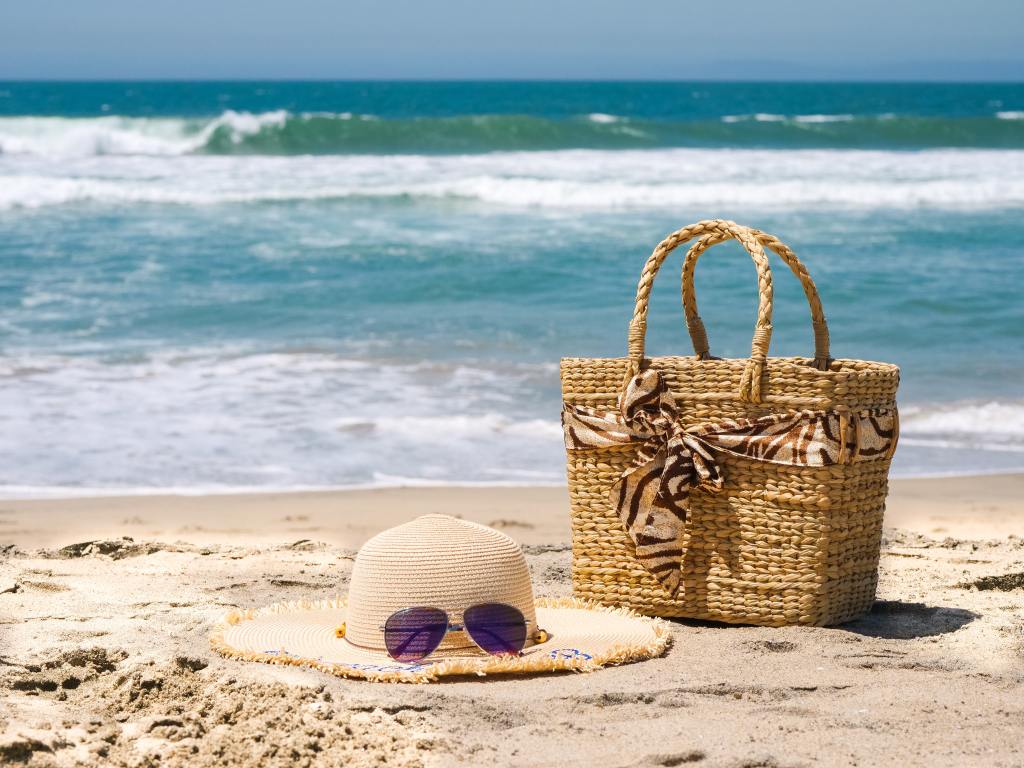 beach-bag-sunglasses-hat-on-shore