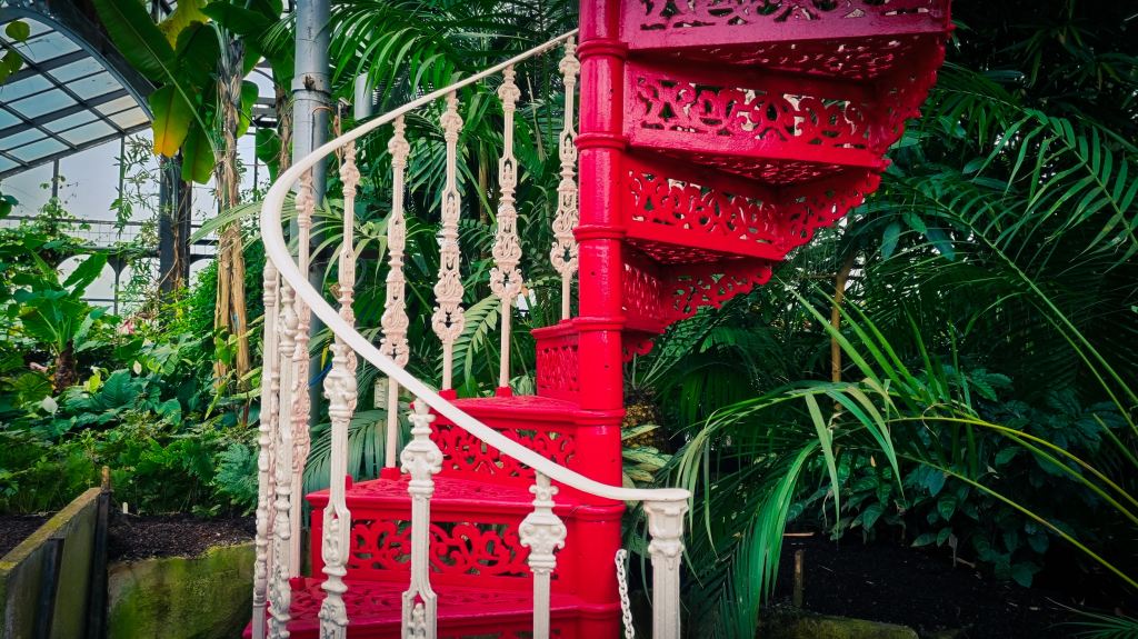 red-spiral-staircase-with-plants-in-background