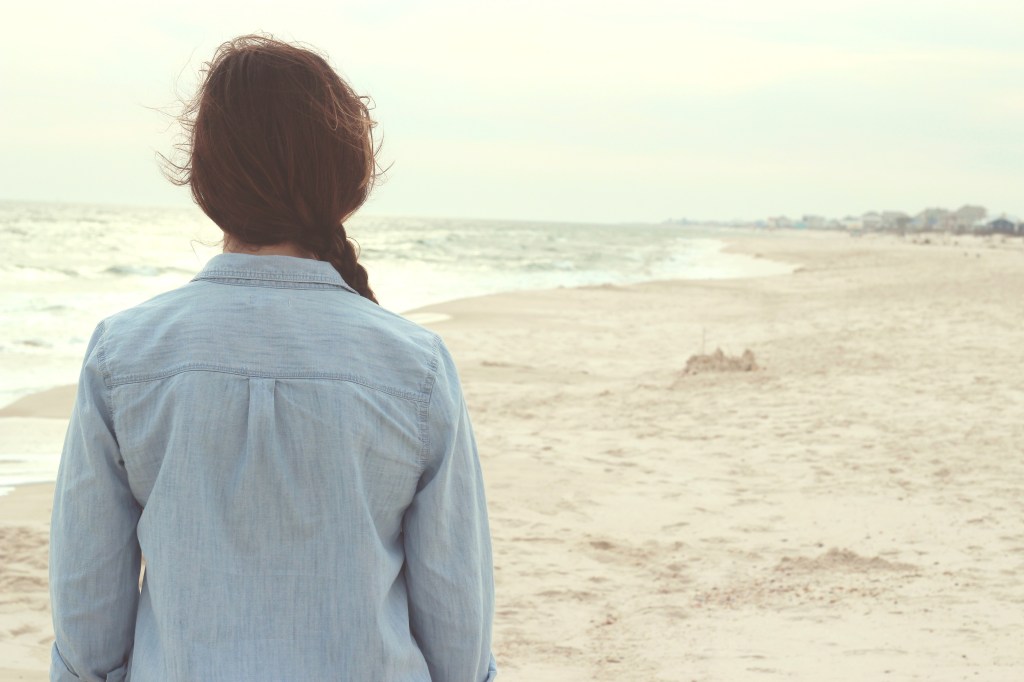 woman-facing-away-from-camera-on-beach