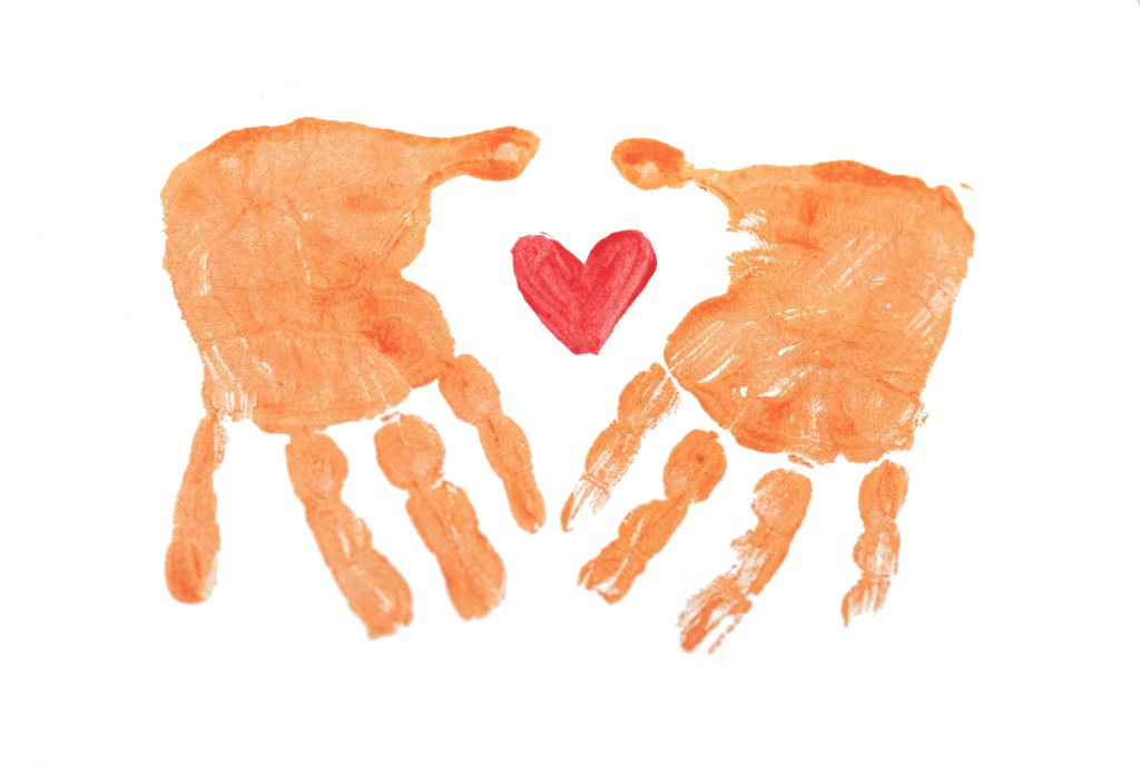 orange-handprint-in-paint-with-red-heart